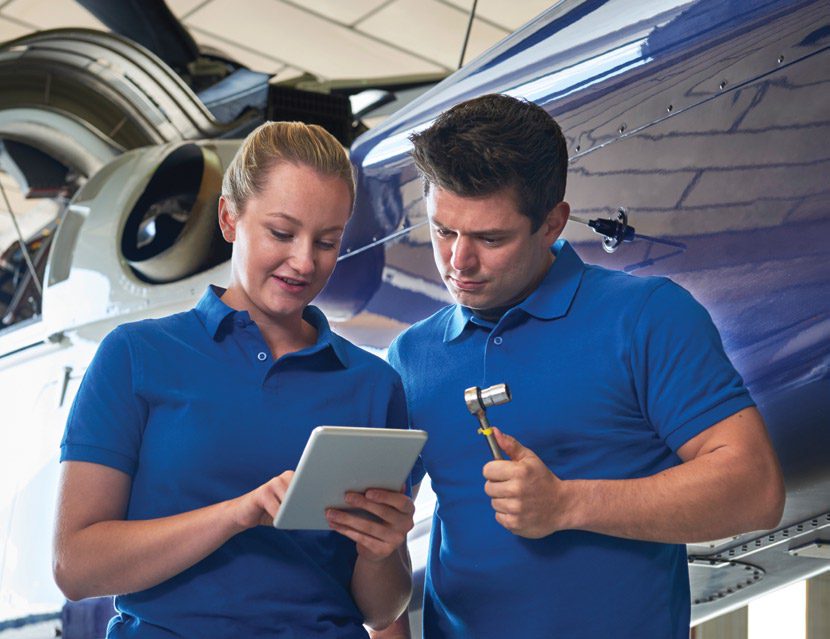 Two people working on plane